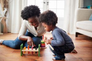 mother and son playing with wooden toys