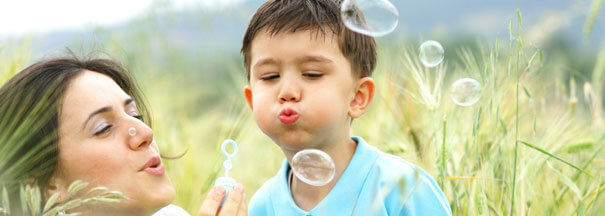 autism-resources-mother-blowing-bubbles-outside-with-son