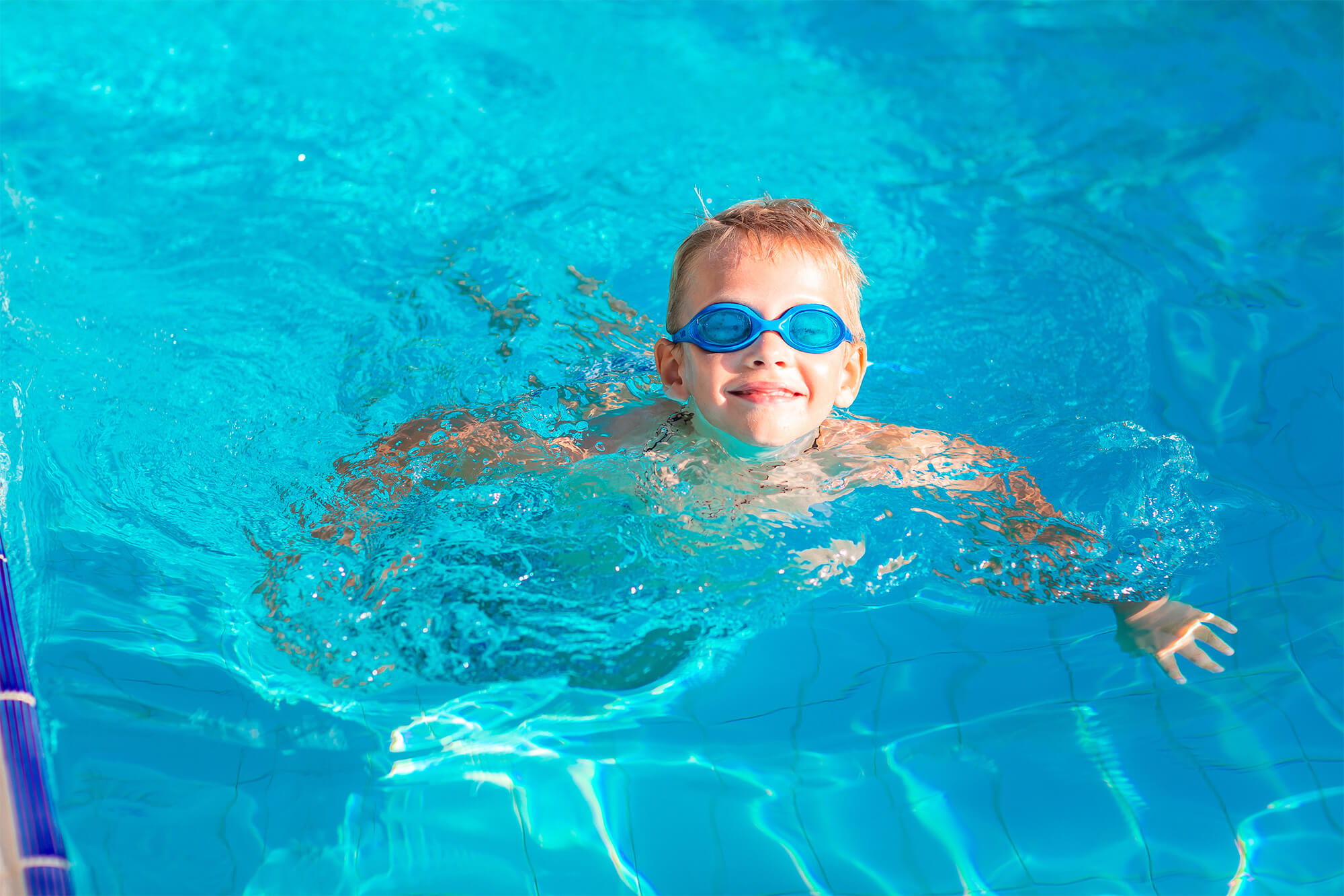Cute Happy Little Boy In Goggles Swimming