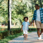 dad and young son on walk in park