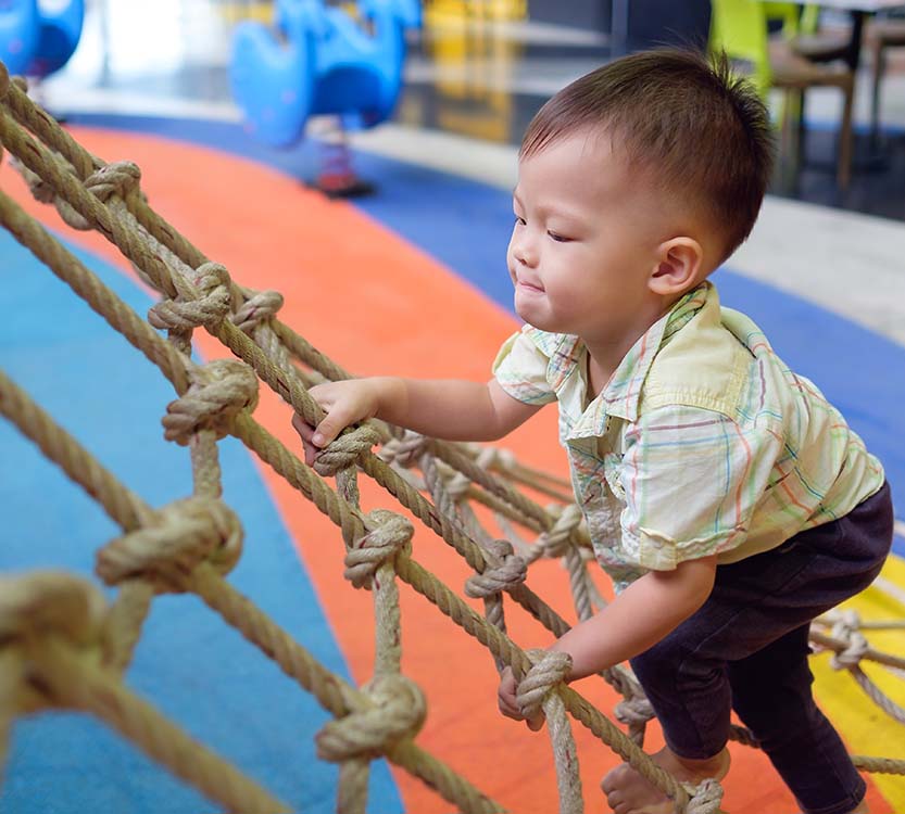 toddler playing at sensory friendly play gym